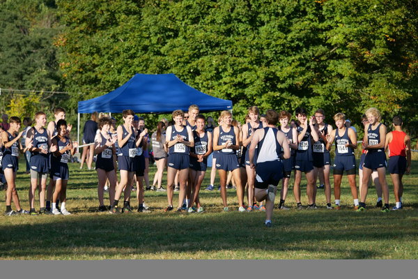 The WMC boys XC team stands on the starting line, cheering for Captain John DelGuercio