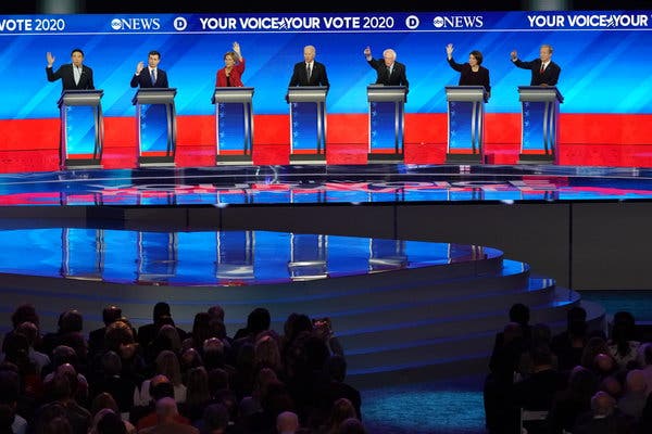 Following a muddled caucus in Iowa, seven Democratic primary candidates gathered in New Hampshire, the next state to vote, for a fractious debate which served only to highlight the volatility of the field. From left to right: Andrew Yang, Pete Buttigieg, Elizabeth Warren, Joe Biden, Bernie Sanders, Amy Klobuchar, and Tom Steyer. Photo credits: Chang W. Lee/The New York Times