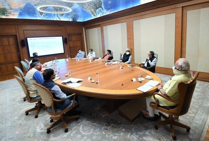 The PM from India meets to converse on a plan for vaccines and testing, being responsibly socially distanced and wearing masks to protect the other members of the meeting