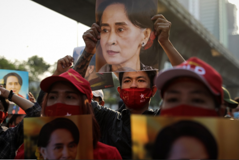 Protesters hold up photos of State Counselor Aung San Suu Kyi, de facto leader of Myanmar, at the embassy in neighboring Thailand. In a bloodless coup, the military of Myanmar—the Tatmadaw—overthrew Aung San Suu Kyi and the civilian government following a decisive loss in the national elections, which it declared fraudulent. The events represent a culmination of Myanmar’s fall from grace over the past few years; formerly welcomed as a democratic experiment, the country has since been plagued by ethnic conflict with a systematic genocide against its Rohingya minority. Photo credits: Lauren DeCicca/Getty Images.
