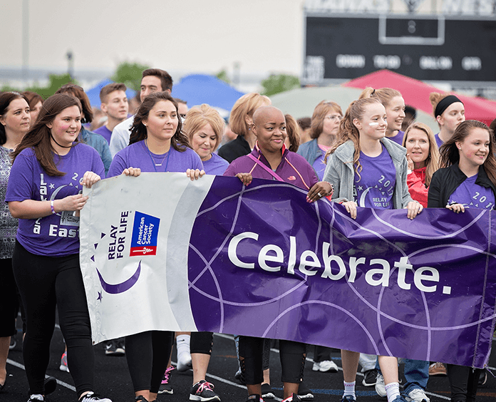 Relay+For+Life+volenteers+walk+together+to+raise+awareness+and+donations+to+help+find+a+cure+for+cancer.+%28American+Cancer+Society%29+