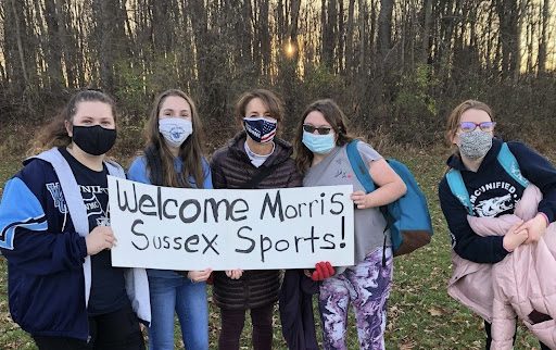 Lucie Gibbons (right) helps welcome Morris Sussex Sports to watch a Unified practice. 