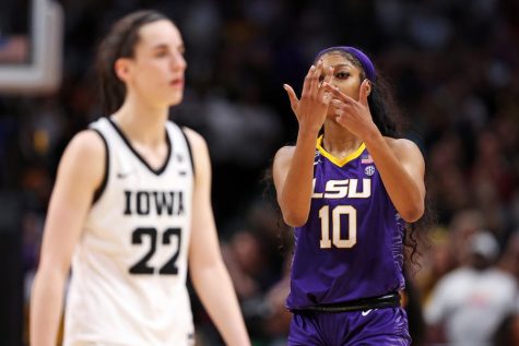 LSU Star Angel Reese Doing The Ring Me Gesture At Iowa Star Caitlin Clark via (dailytarheel.com)