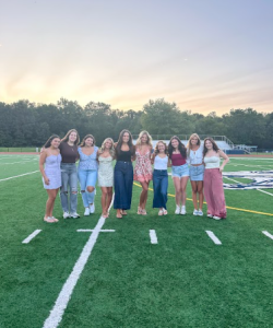 Left to Right: Seniors Violet Caruso, Quinn Commerford, Hannah Marney, Rylie Kaplan, Morgan Forlenza, Olivia Budd, Elyse Cuccaro, Abby Nasisi, Eliza Olsen, and Ella VanCoevering smile for a picture in front of the golden sunrise!