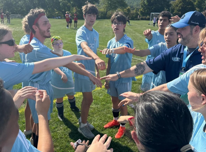 WMC Unified huddles up for an encouraging team chat before Mount Olive game.