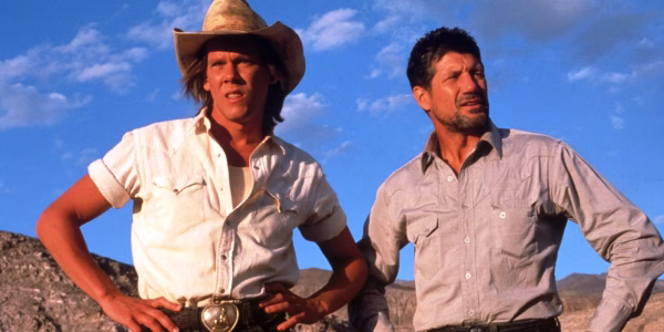 (Left to Right) Kevin Bacon and Fred Ward standing on Business. 