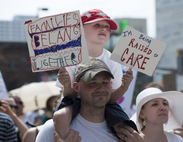 A young boy and his father protesting against the act of ICE separating children from their families in Minneapolis, MN.
